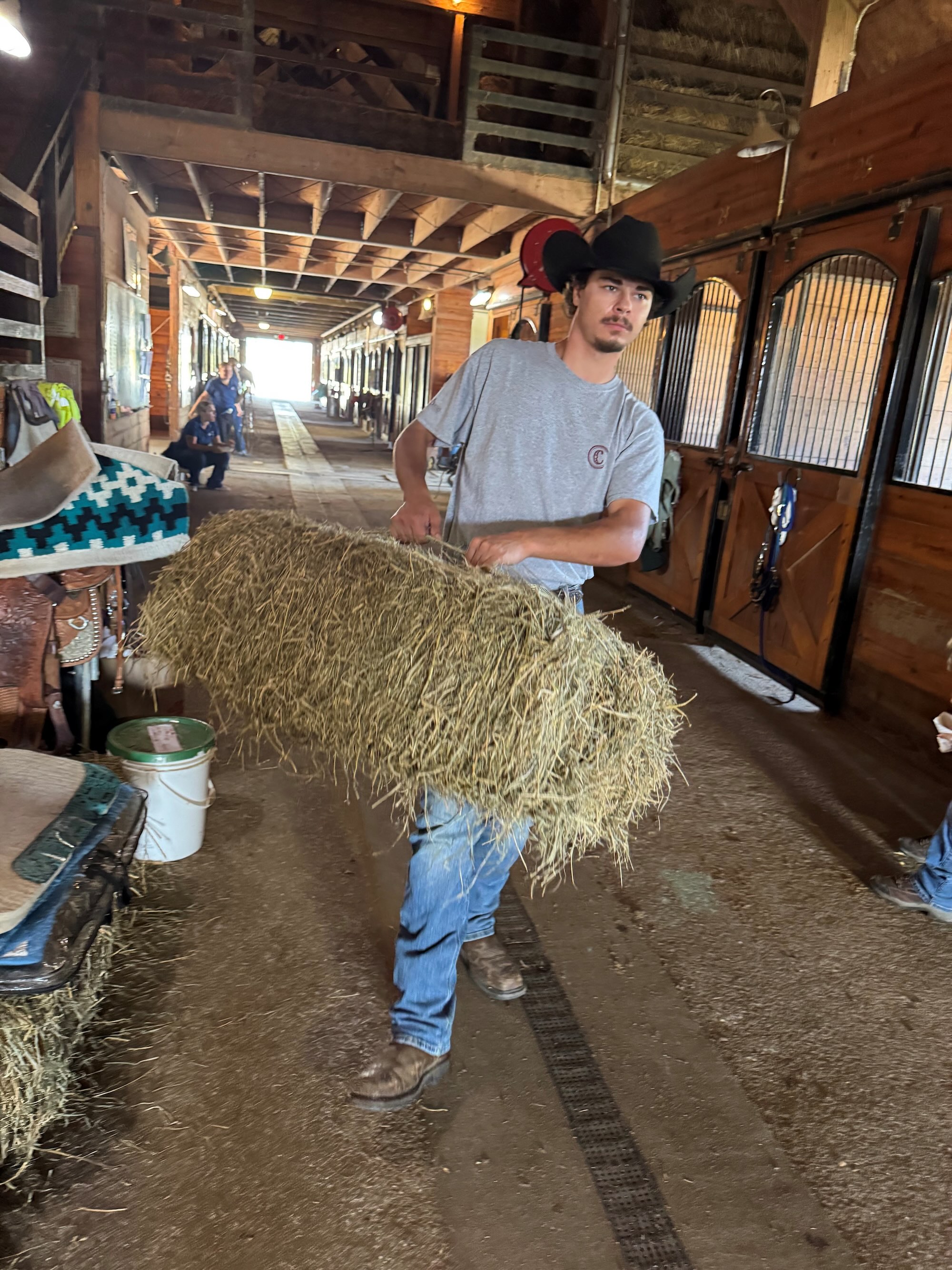 Braden carrying a bale of hay