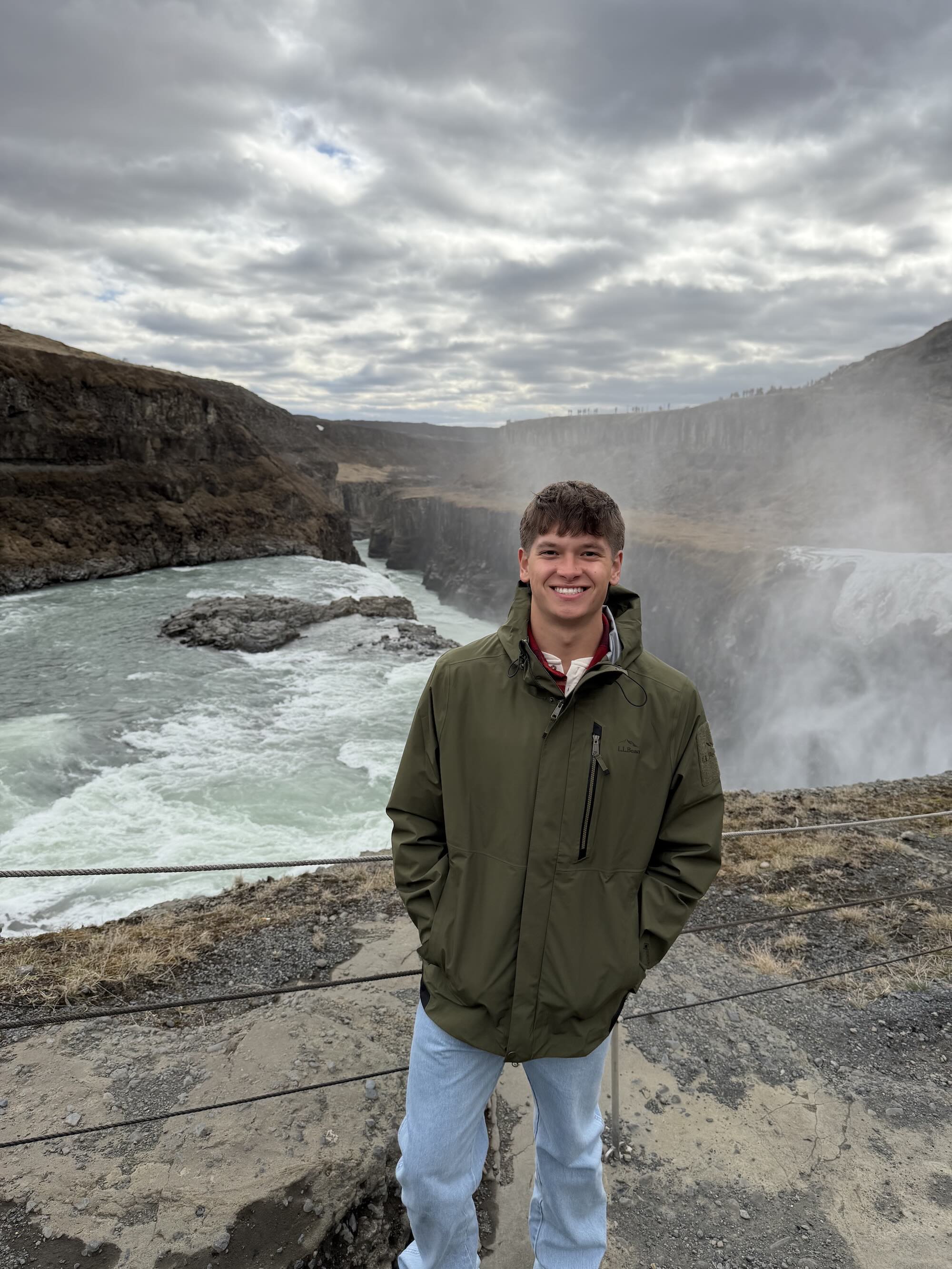Traceson Gearhart standing on top of a rushing waterfall