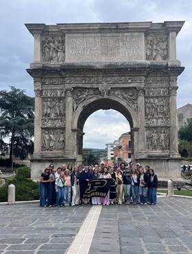 Study abroad group standing in front of Italian architecture