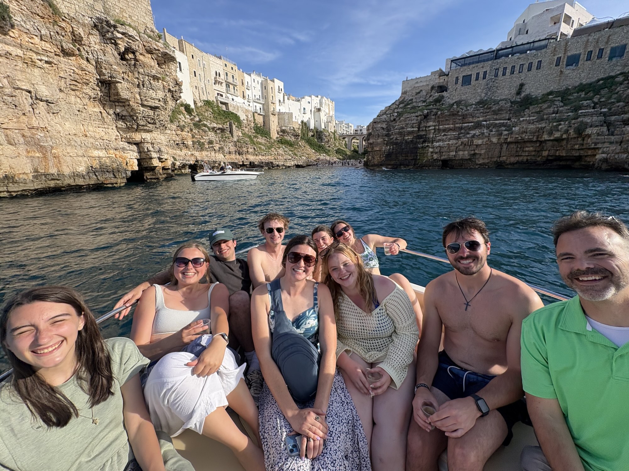 Study abroad group posing on a boat on the river