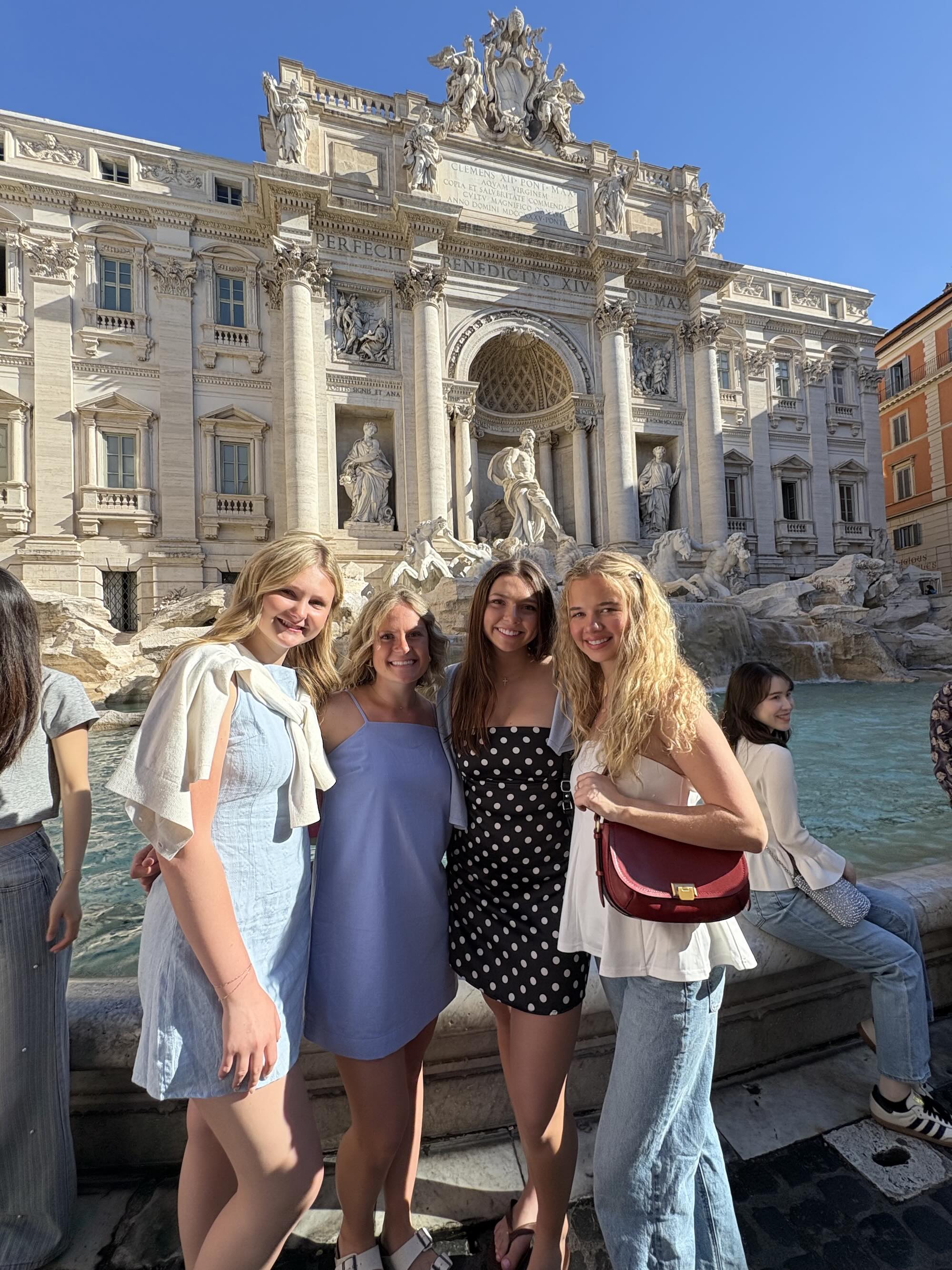 Small group standing in front of Italian fountain