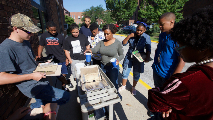 students at outdoor agricultural demonstration on campus