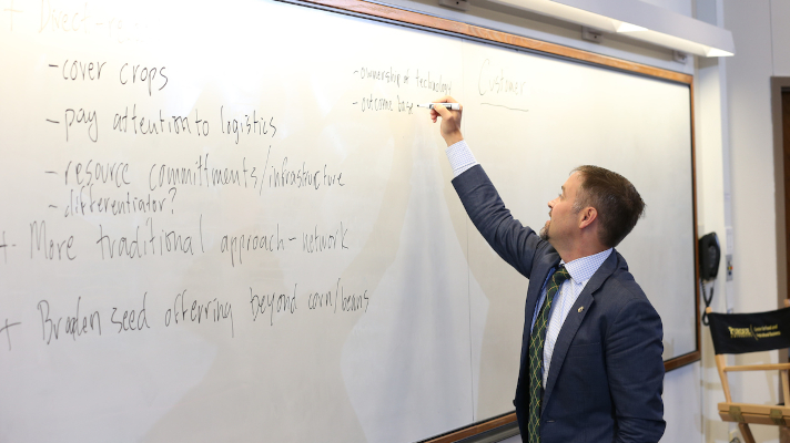 professor writing on a whiteboard