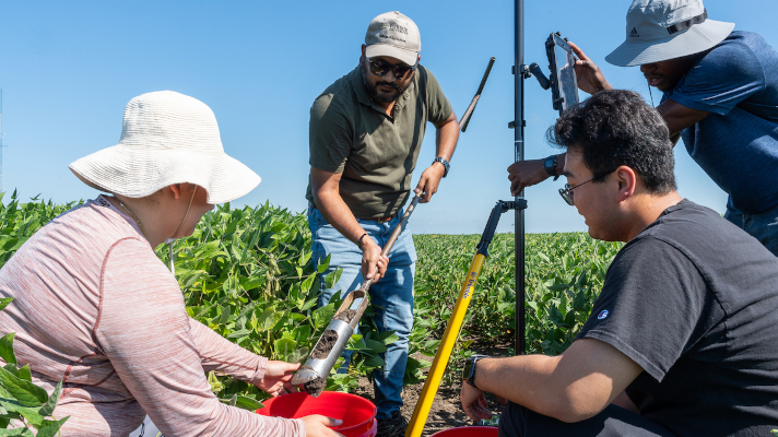 students doing soil testing on a field