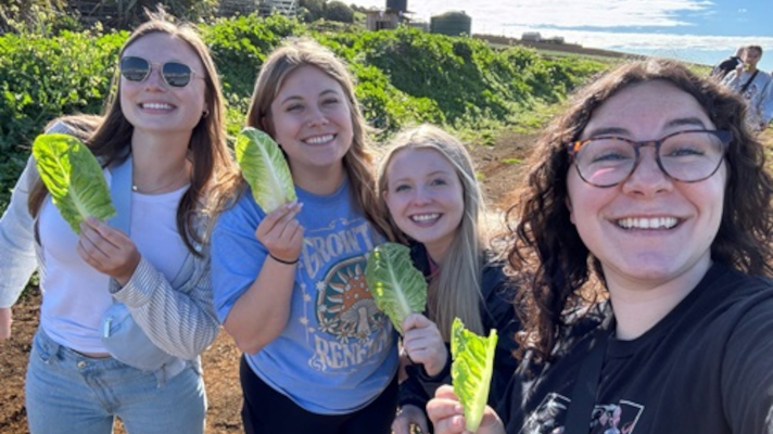 group of agriculture students abroad holding lettuce