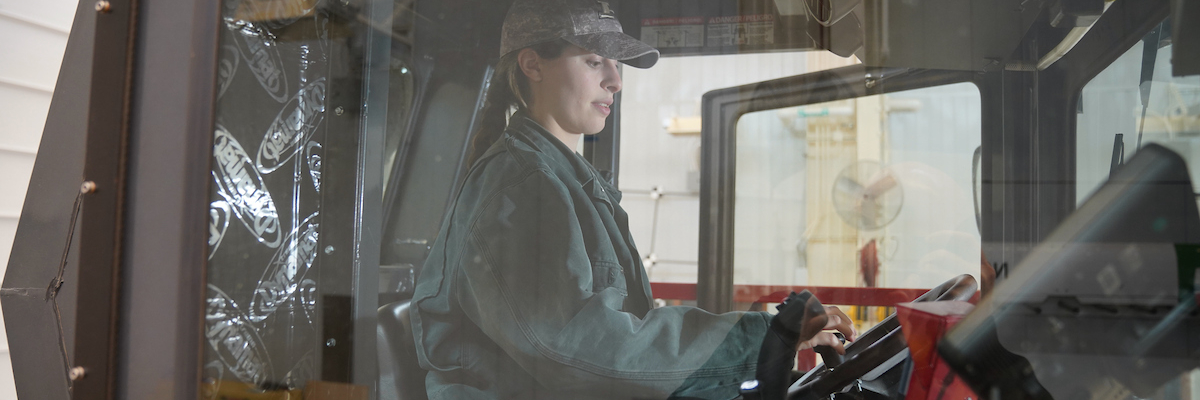 student operating farm equipment 