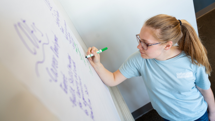 AgEd student writing on whiteboard