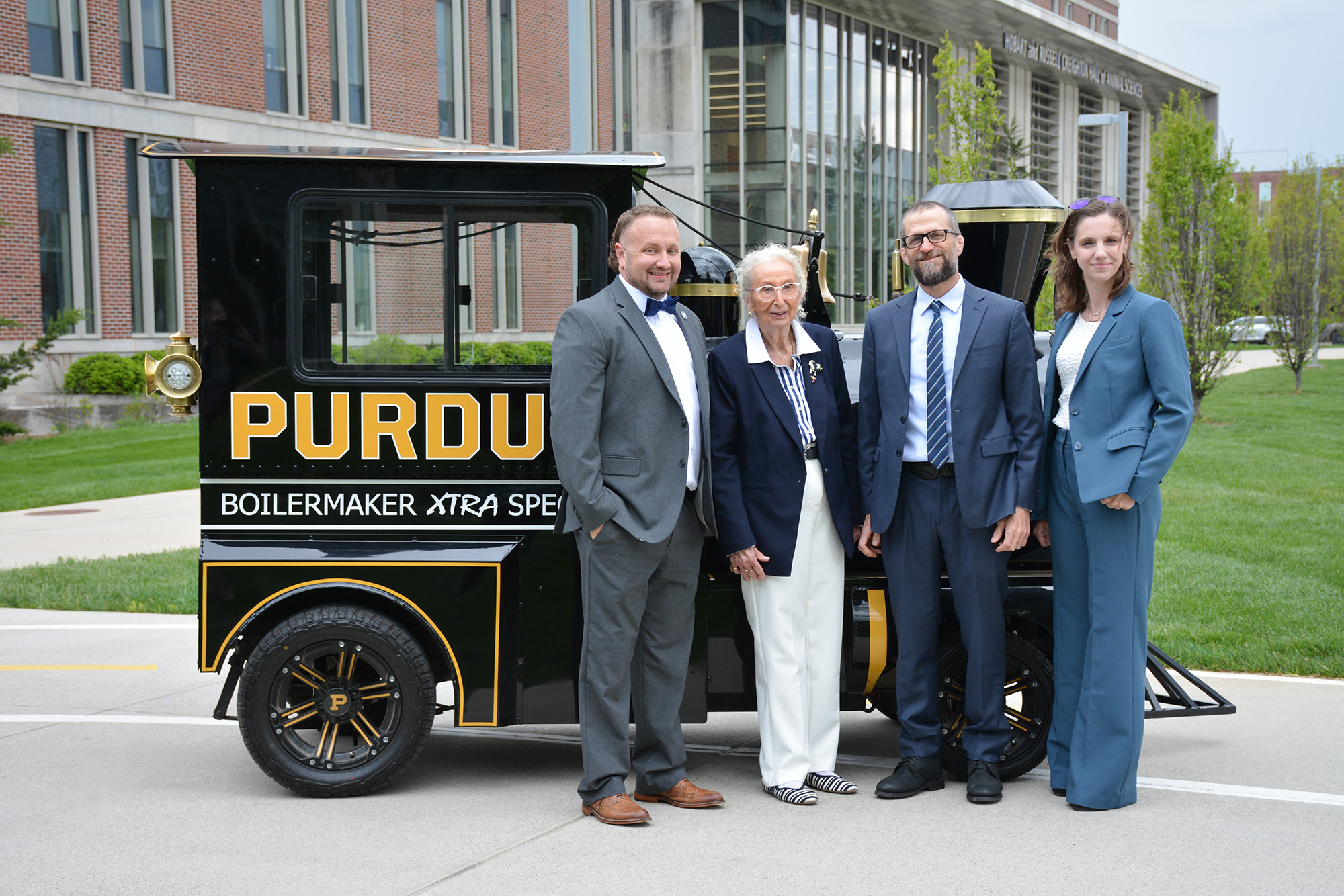 Daniel Wilson, Gretchen Hill, Paul Ebner and Kate Borders stand in front of the Boilermaker Extra Special.