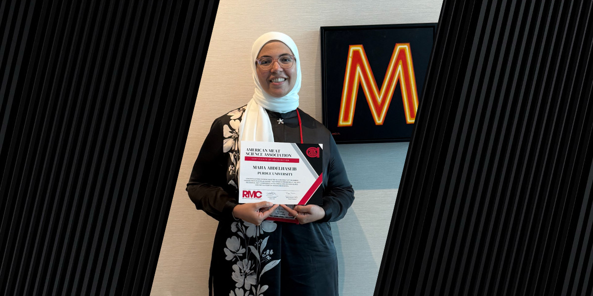 A person holding a certificate from the American Meat Science Association awarded to Maha Abdelhaseib of Purdue University, with the acronym 'RMC' at the bottom.