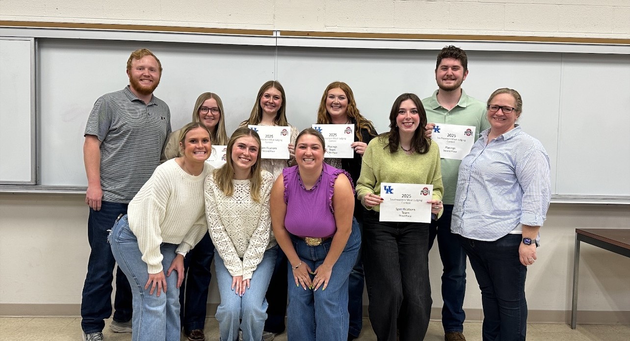 The Purdue Meat Judging Team poses in a classroom holding certificates from the 2025 Southeastern Meat Judging Contest. The team is smiling and dressed casually, standing in front of a whiteboard.