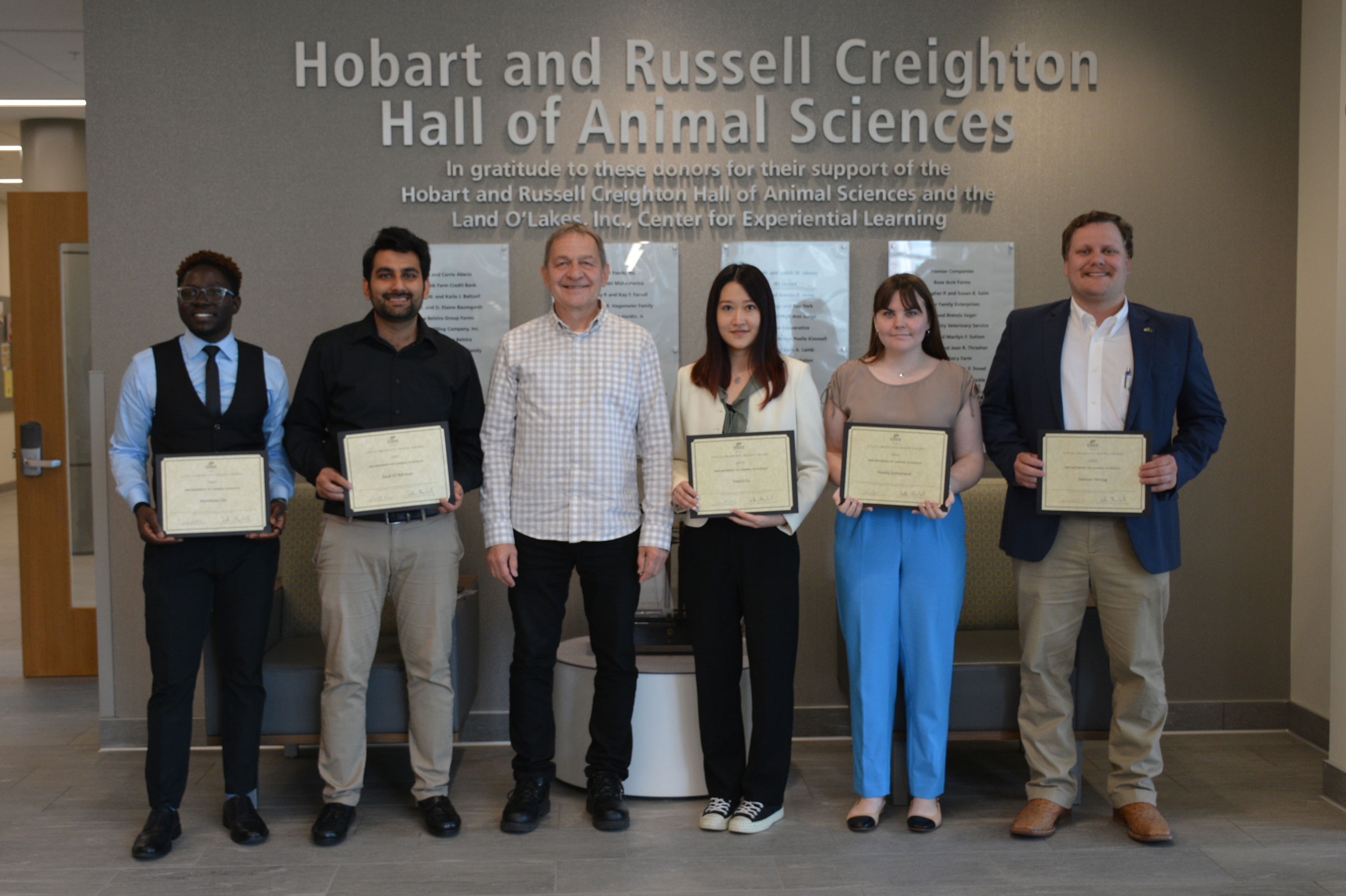 a group of people holding awards