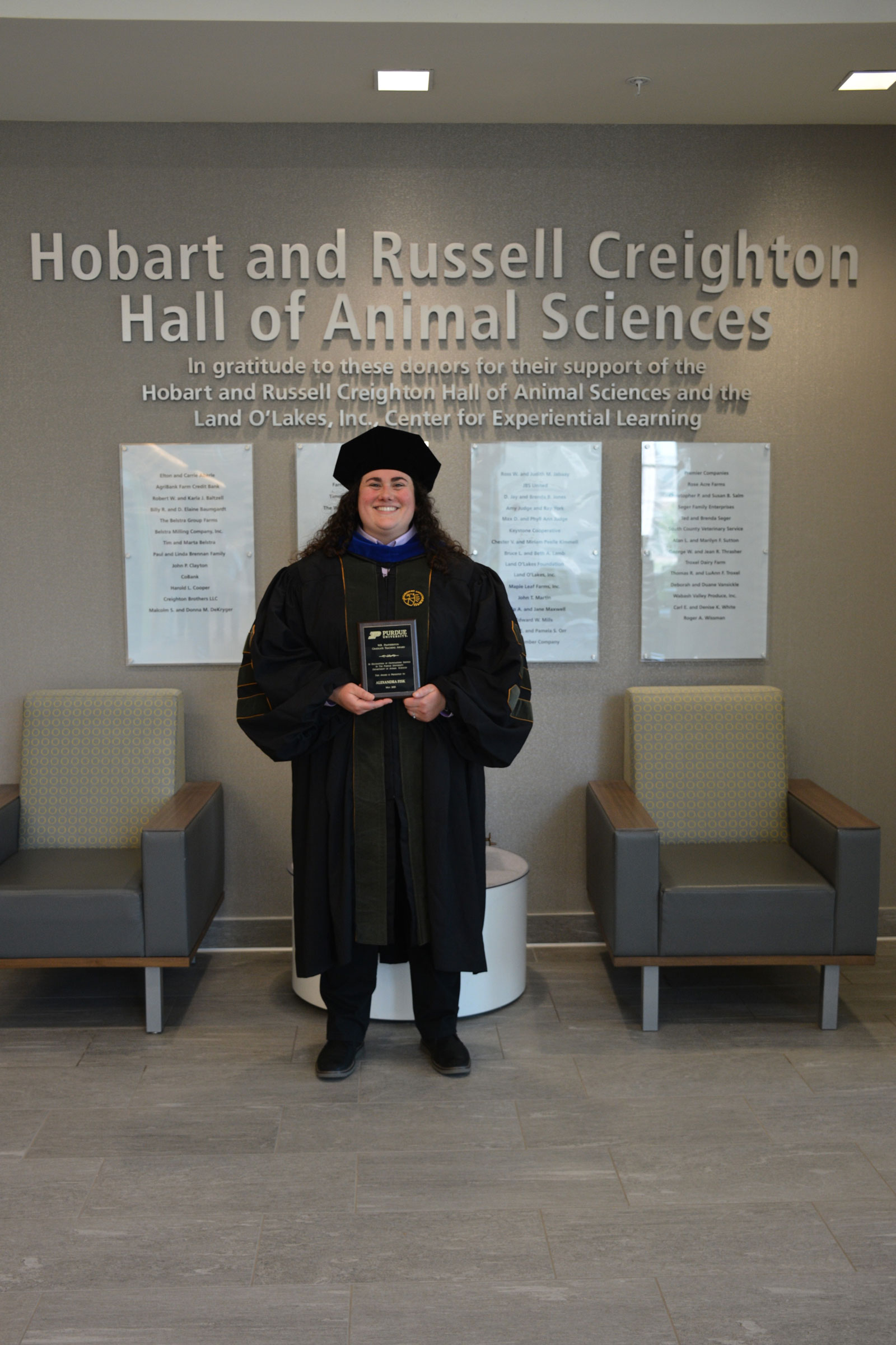 a woman holding an award