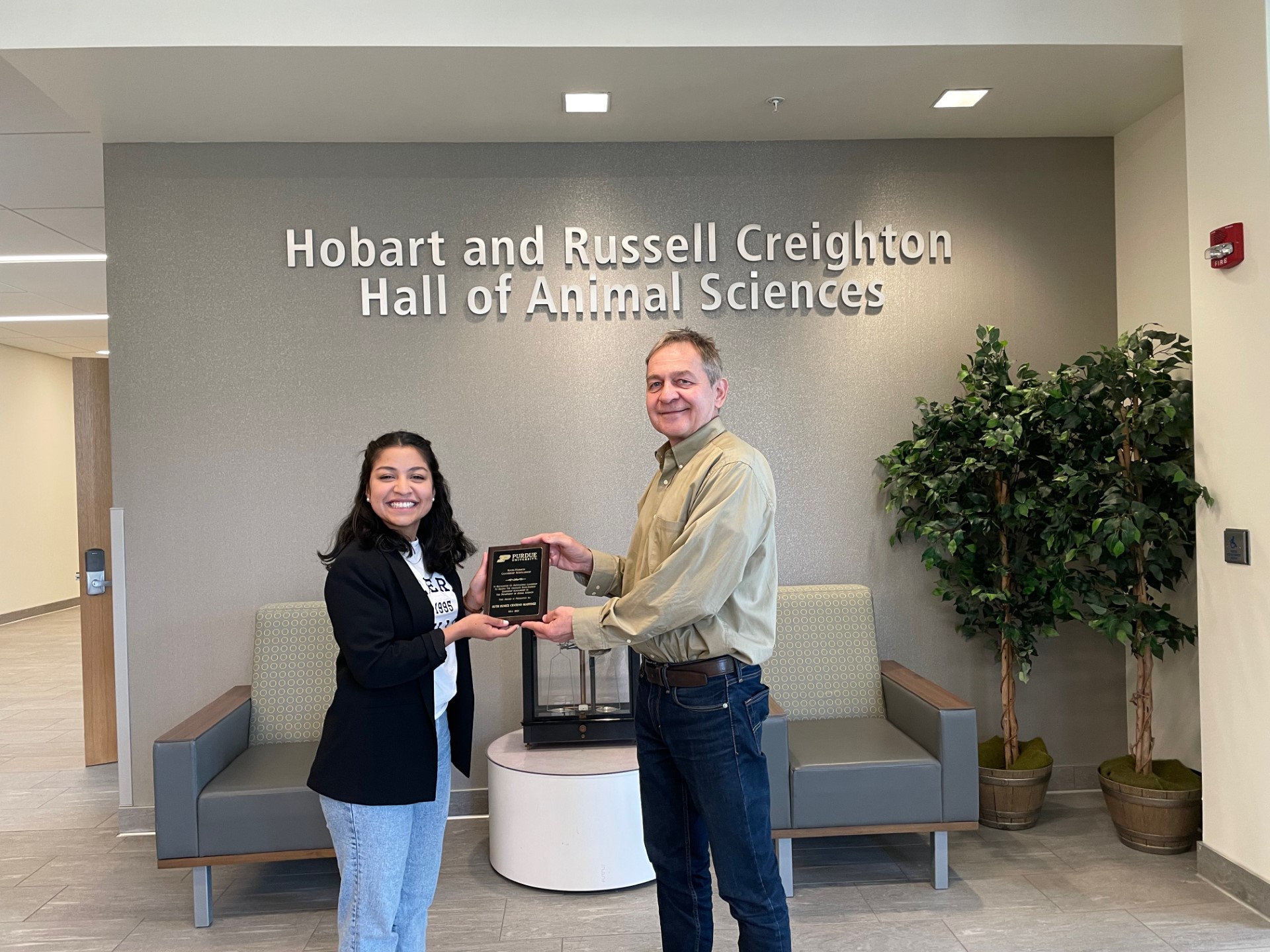Ruth Eunice Centeno Martinez accepting the award from Dr. Zoltan Machaty, Chair of the Graduate Program Committee at the Department of Animal Sciences.
