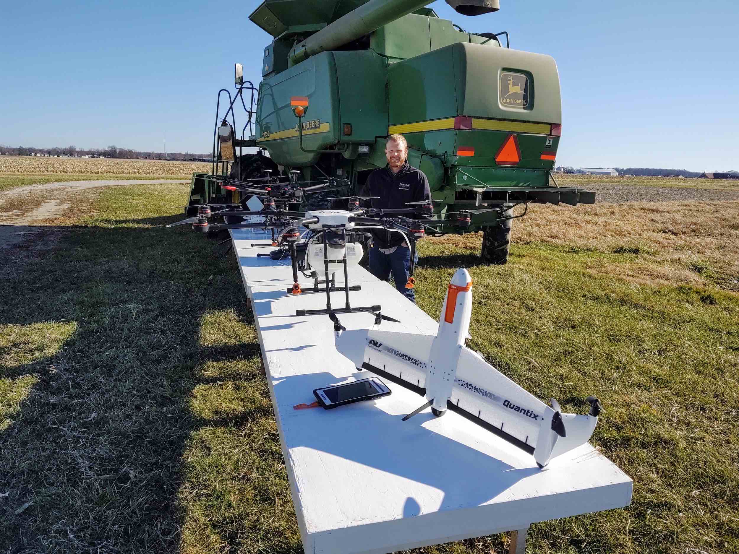 Image of a man workingon the fields with drones and agriculture equipment 