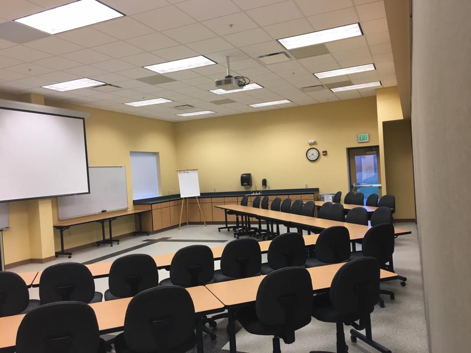 Room 111a has the wall divider pulled to separate the room into two spaces. One space is shown in classroom style seating facing the front white board with seating for 20 guests.