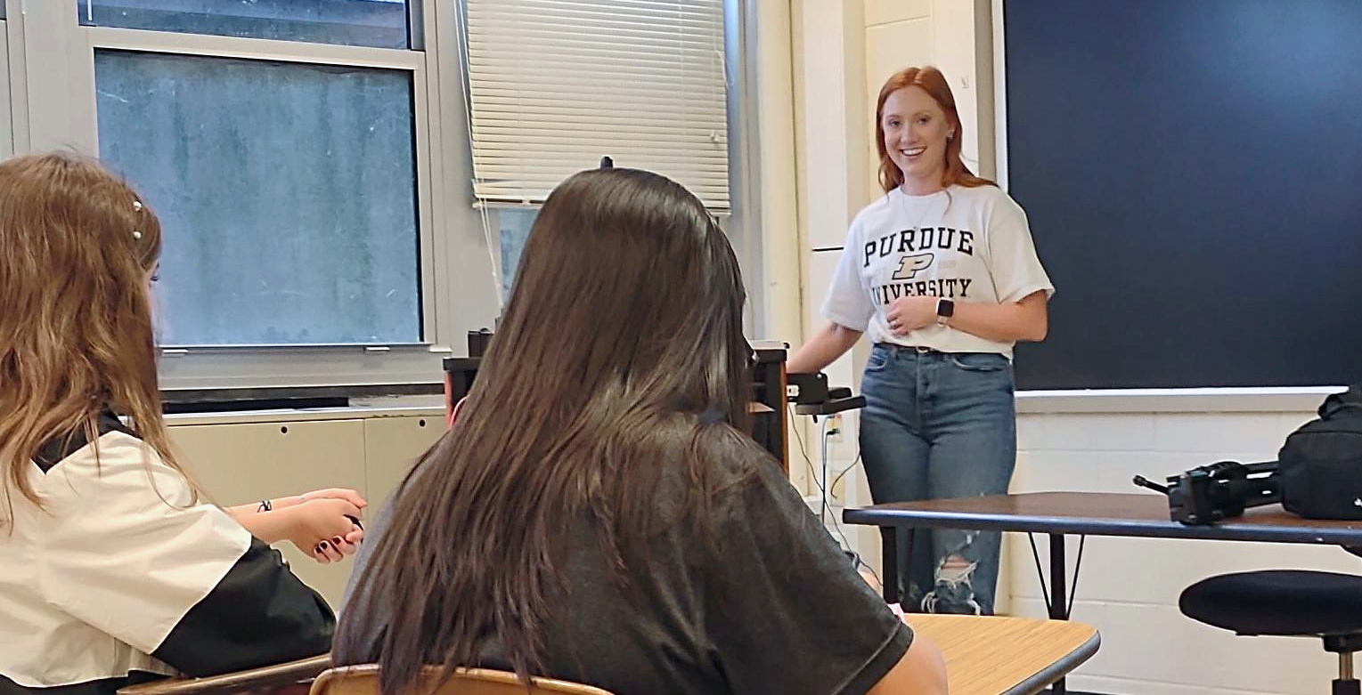 Student leading discussion in front of classroom