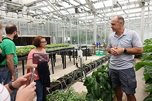 Dr. Petrus Langenhoven brings teachers on a tour of the Purdue greenhouses.