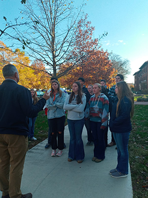 A scientist explains tree identification on the Purdue campus to students 