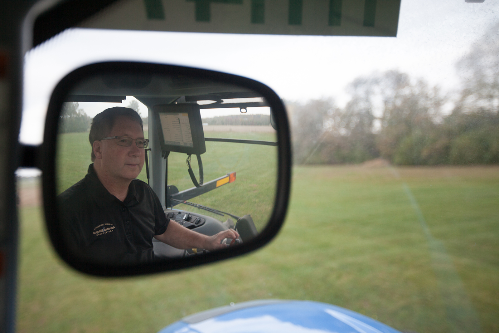 Dennis Buckmaster in a tractor's rearview mirror