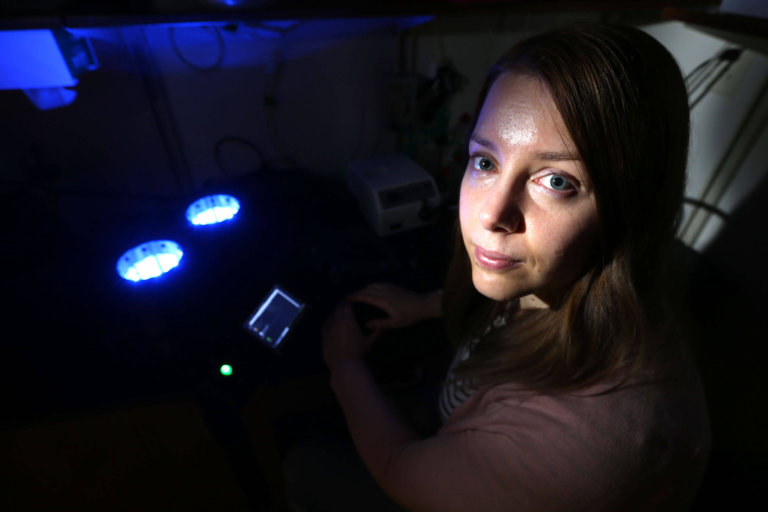 Image a of a young female in a dark research room