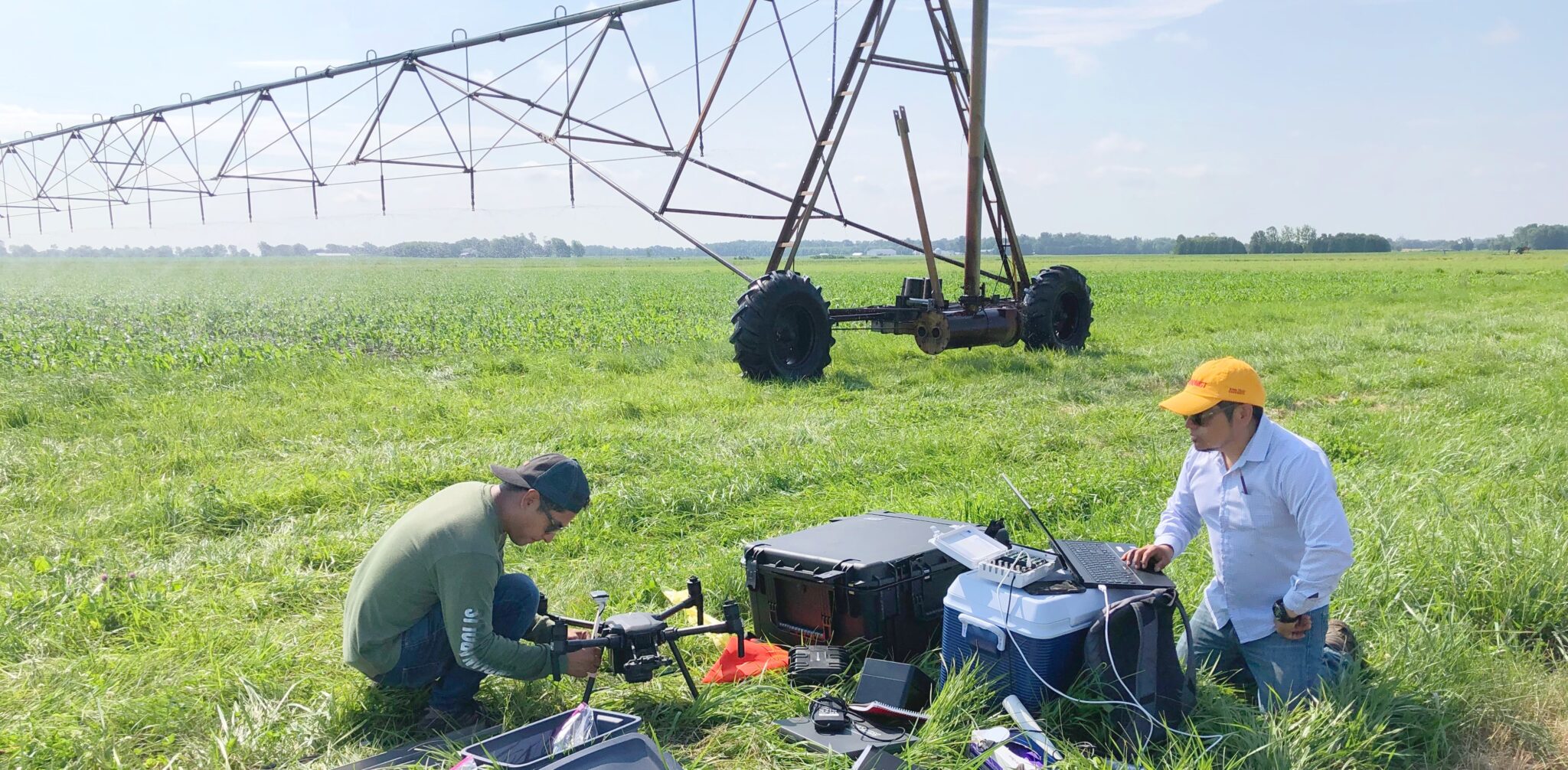 Postdoctoral researcher Carlos Gongora and lab technician Andrés Cruz prepare equipment before deploying a weather station and UAV for data collection at Pinney Purdue Agricultural Center.