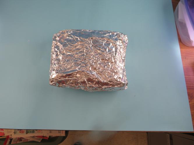 Turf sample wrapped in aluminum foil, folded to seal.