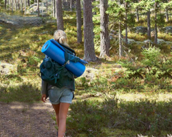 To people with hiking backpacks walking down a trail