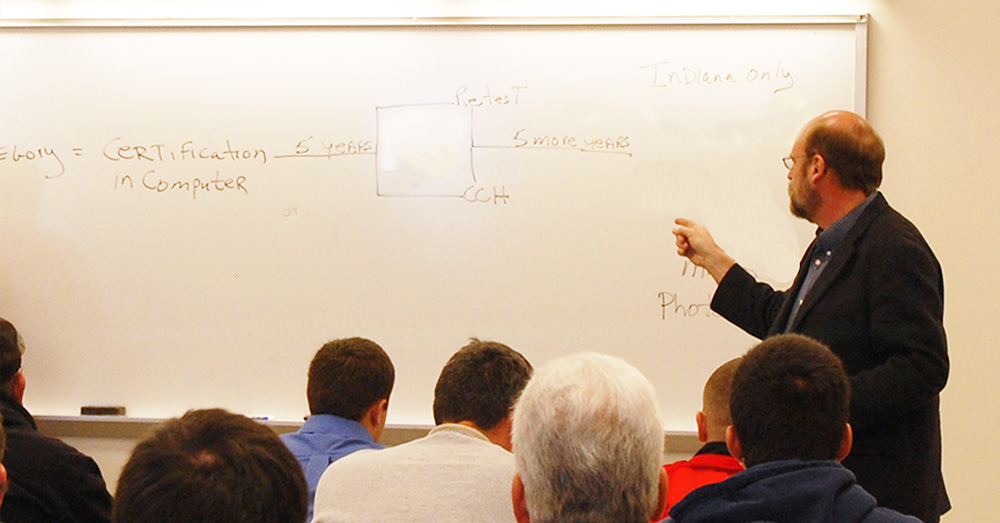 Purdue PPP course instructor pointing at white board