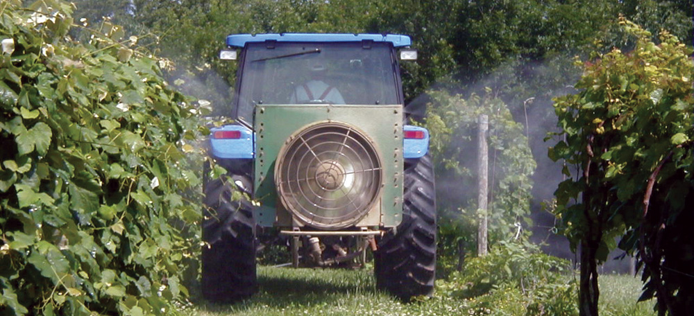 Image of a tracktor spraying pesticides