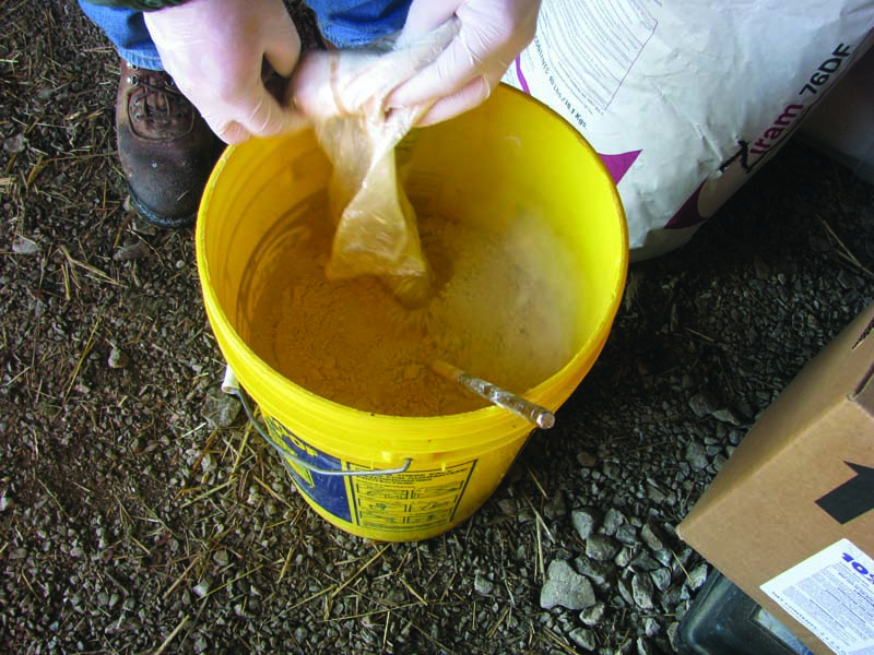 mixing herbicides in a bucket 