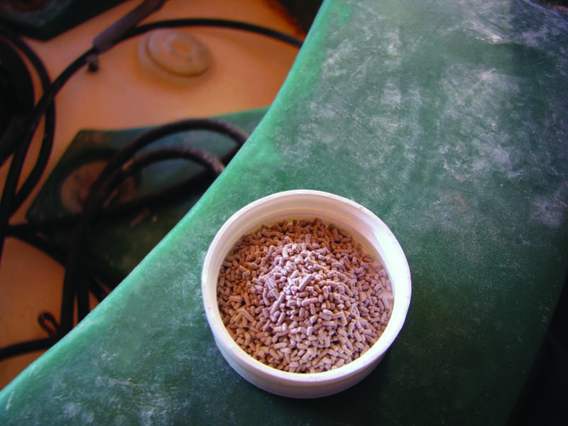 pink dry granulated mixture in small cup