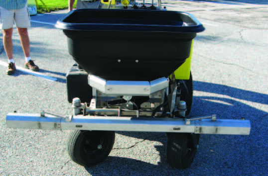 A boom-type ride-on sprayer
