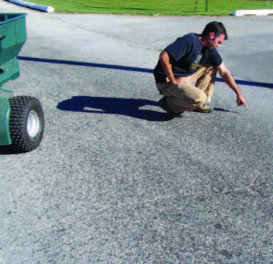 Person locating each edge of the spray pattern where the pavement is consistently wet. Measure from edge to edge to get the effective spray width.