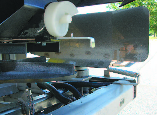 The edge guard (deflector) is a physical barrier that prevents the fertilizer from going onto impervious surfaces. 