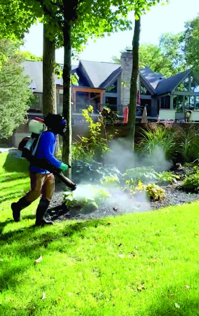 Man spraying mosquito repellent