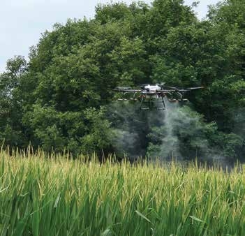 drone spraying solution across the field