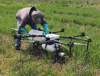 This photo shows an operator filling a drone solution tank.