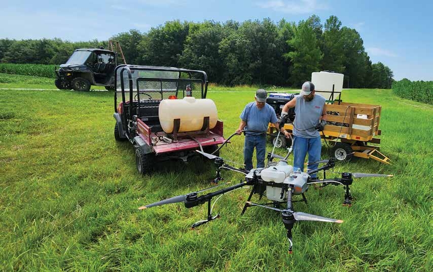 people operating drone in the field