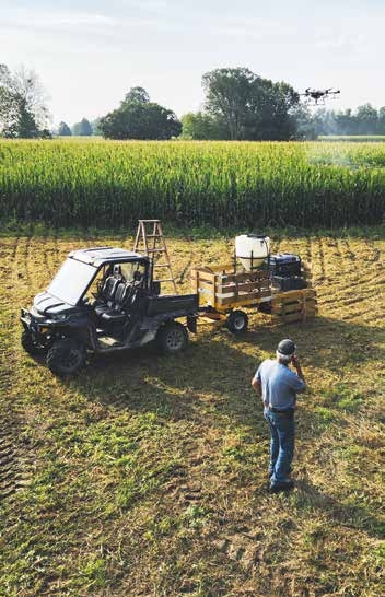 farmer in field with pesticide
