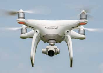 This quadcopter (four rotors) drone hovers near the ground.