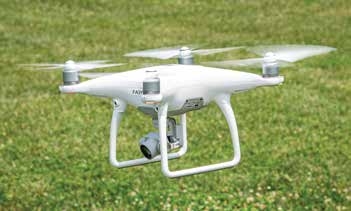 drones flying over crop field
