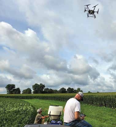 Resaercher using a drone in a field