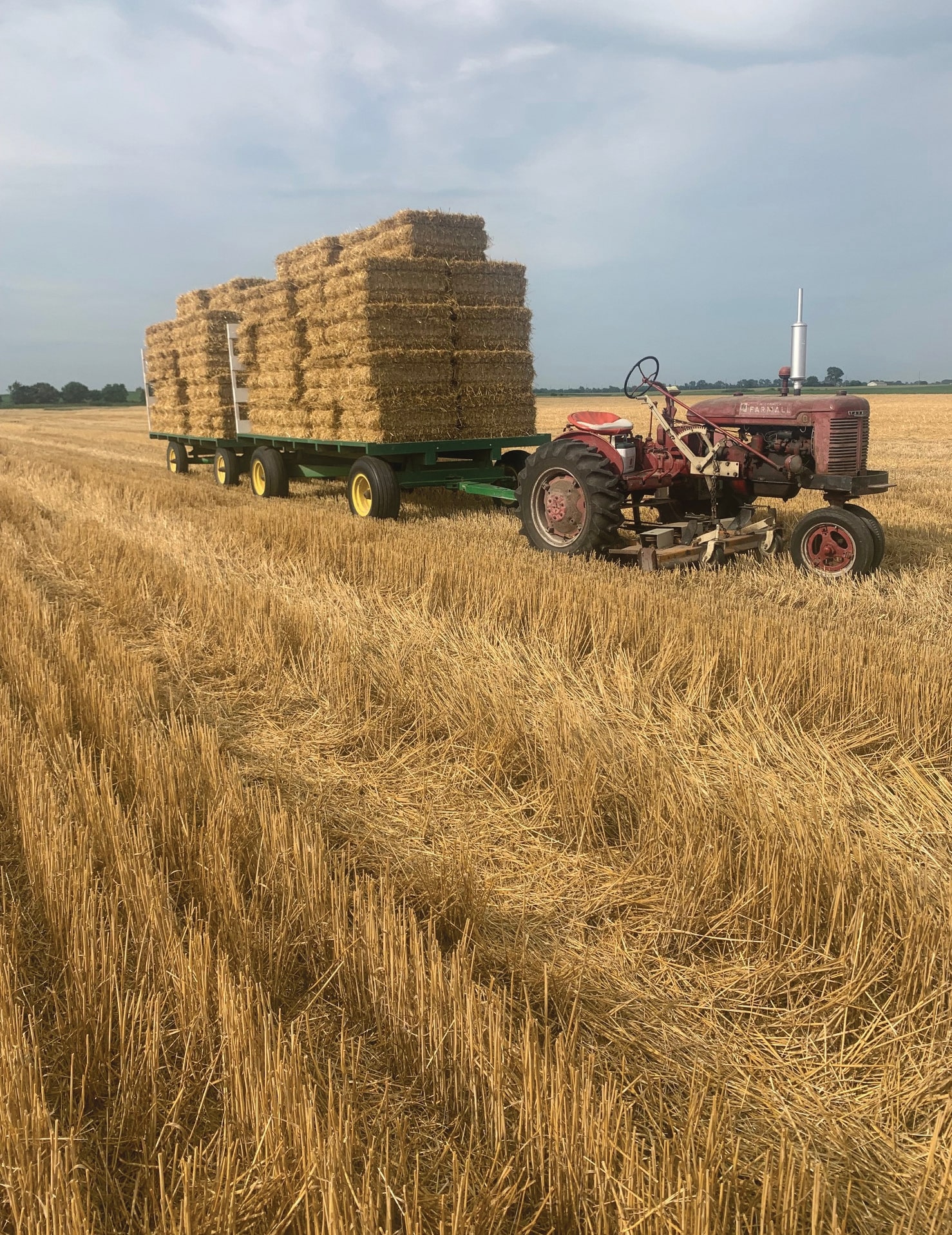 truck and hay load wagon attached by a hitch pin