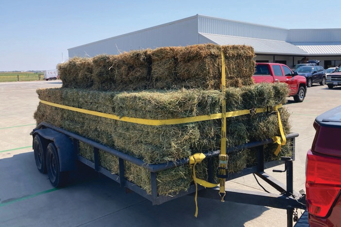 This is a very complicated situation given that the operator is moving less than 50 small square bales on a short trailer.