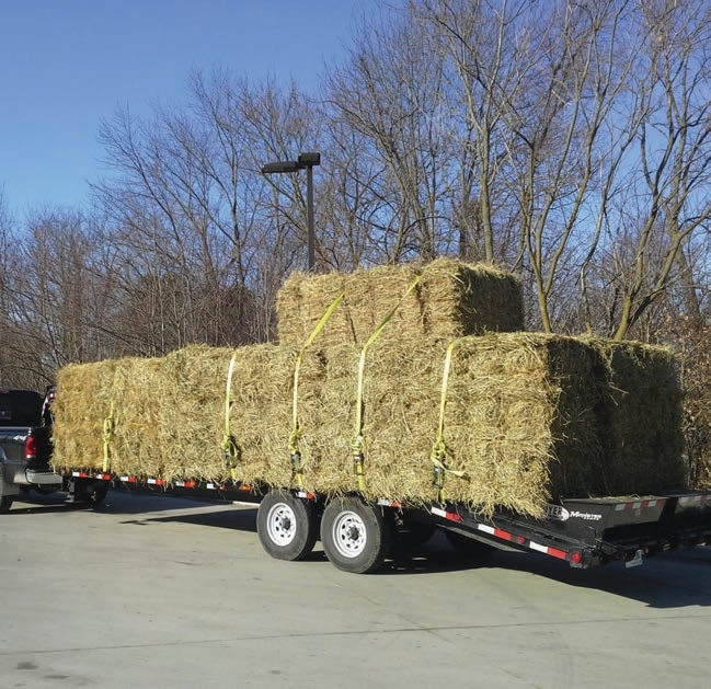 While there are plenty of straps on this load to keep it secured to the deck of the trailer, another strap around the back of the load to keep bundles from falling off the back of the trailer is recommended.
