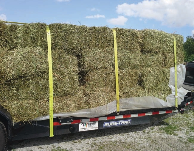 This multi-layer stack of hay will have enough straps running from side-to-side, but it is short one strap on top running from front to back.