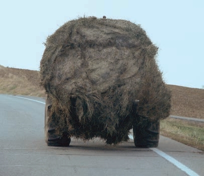 This photo shows a good example of what not to do when transporting a round bale on a 3-point hitch.