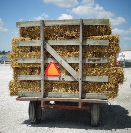if it is on a public road and travels less than 25 mph a slow-moving vehicle sign is required. The answer is “no” if it only moves on private property