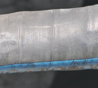 These photos show hoses worn from rubbing. Even covers might not protect underlying hose layers as shown in the photo of the orange hose.