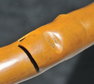These photos show hoses worn from rubbing. Even covers might not protect underlying hose layers as shown in the photo of the orange hose.